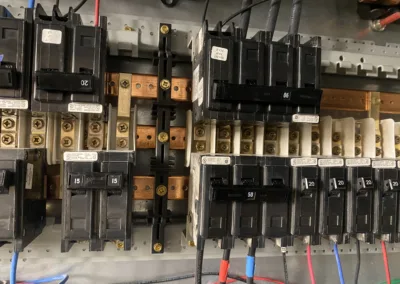 Industrial electrical circuit breakers mounted on a panel.