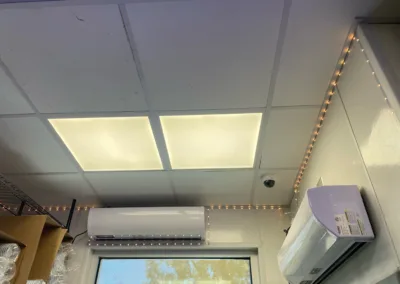 Interior view showing ceiling lights, an air conditioning unit, and led strip lighting along the perimeter.